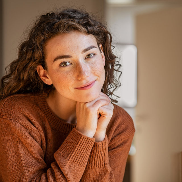 Serene young woman looking at camera
